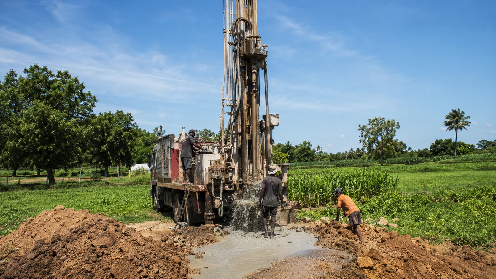 Well contracting machinery working beside agricultural fields